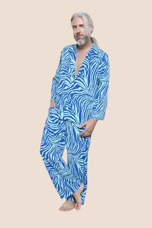 Man wearing a blue and white patterned pajama set on a brown background