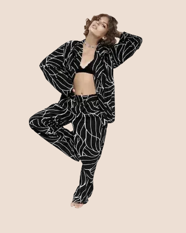 Person wearing a black and white patterned outfit on a brown background