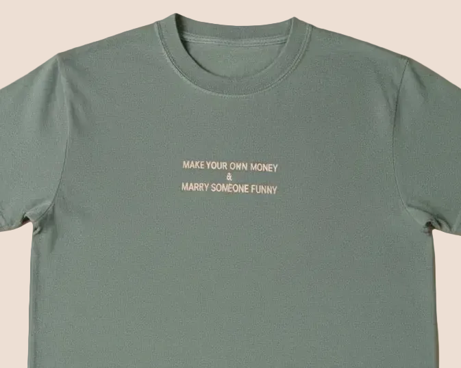 Green t-shirt with text on a beige background