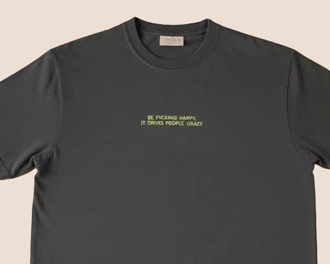 Black t-shirt with yellow text on a brown background